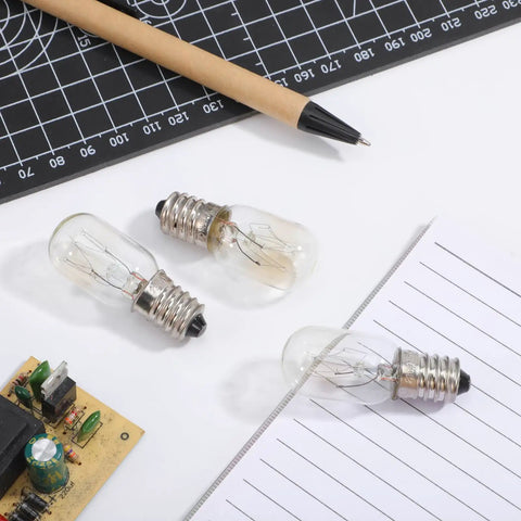 E14 Edison Fridge Bulbs Featuring Retro Tungsten Filament Emit A Legit Warm Yellow Glow Perfect For Microwave Ovens And Wine Coolers This Solid 15 Watt 3 Pack on a workspace with tools.