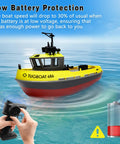 One To Seventy Two Scale RC Tugboat For Pools And Lakes, yellow tugboat with remote control and low battery warning symbol.