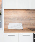 Waterproof Peel And Stick Wallpaper With True Marble Grain For Kitchen Backsplash And Cabinet Makeover Quick Install on wooden countertop.
