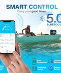 Person on boat using smartphone showing 12V 100Ah LiFePO4 Battery With Bluetooth 5.0 And 100A BMS Low Temp Protection monitoring app.