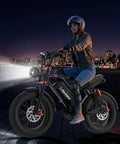 Premium Adult Electric Bike With A Badass 3000W Peak Brushless Hub Motor, Packing A Massive 48V 33Ah Removable Battery For Tough Trail Ripping And Smooth Pavement Cruisin at night on a boardwalk.