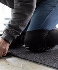 Person wearing Heavy Duty Knee Pad Sleeves with Triple Layer Padding, breathable mesh back, elastic cuff, slip resistant silicone.