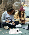 Two kids sitting outdoors using Light T Shirt Heat Transfer Paper Pack 10 Sheets 8.5x11 Printable HTV for DIY tee transfers.
