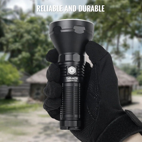 Person holding Catapult Pro SFT70 LED Flashlight Pocket Size Long Throw Beast Beam 1005m Range 2713 Lumens outdoors.