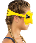 Side view of a woman wearing a yellow Frameless Snorkel Mask Kit With Dry Top Snorkel Ultra Clear Lenses Low Volume Design