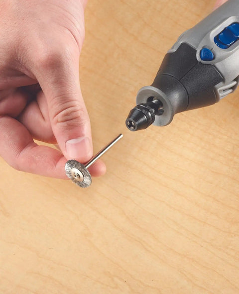 Close-up of a hand holding a polishing bit and fitting it into the Drop Dead Easy Multi Chuck For Rotary Tools.