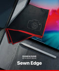 Camera lens microfiber cleaning cloth, sewn edge, black with red border, beside tablet and stylus.