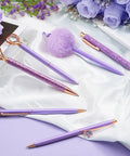 Purple Crystal Diamond Pens Set 8 Metal Pens In Different Styles With Black And Blue Ink For Journaling And Office Use For Women Glam Back To School Essentials And Girl Birthday Gift Idea on white fabric with purple flowers.