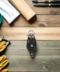 Nylon Pulley Block for Sailing Rigging and Marine Tackle Gear with Bearing Wheel shown with tools on wooden surface.