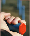 Close-up of hand holding a large orange and blue rubber hydraulic oil service plug from 42 Piece Hydraulic Oil Service Plugs Set In Large Medium Small Sizes Made Of Durable Rubber For Oil Pipes And Hoses Universal Fit For Hydraulic Systems And Irrigation Reusable Leakproof Seals.