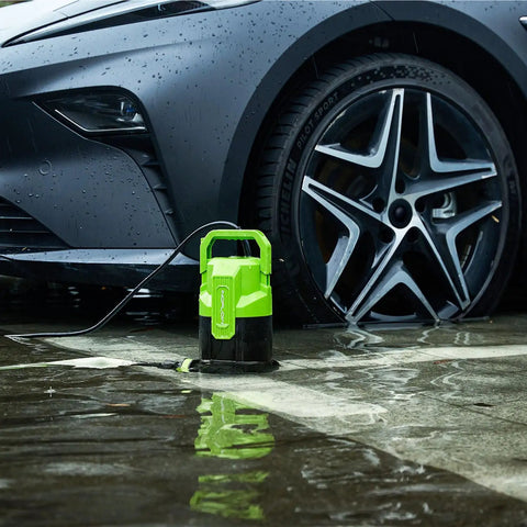 Three-Quarter HP Submersible Sump Pump beside a car, green 3/4 HP model for drainage and water removal, 20 ft cord in use.