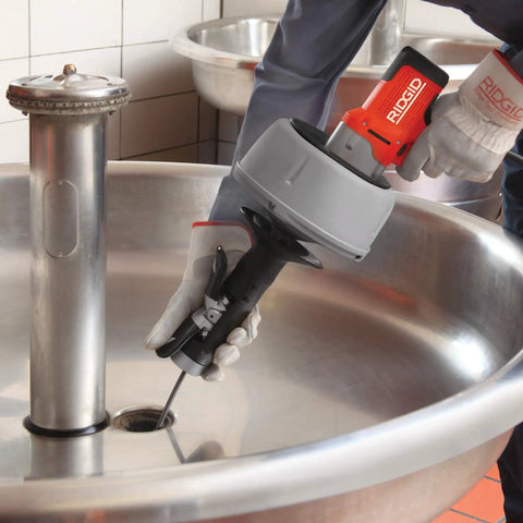 K-45AF Air Powered Drain Cleaner 230V Drum Auger in use over a sink, designed for sewer pipes and clogs.