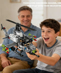 Boy holding Cobra Attack Helicopter Building Block Set, 512 Plus Pieces, Compatible With Lego Plane Sets, smiling with adult in background.