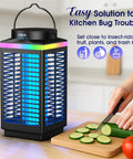 Cordless Rechargeable Bug Zapper Outdoor 4 In 1 4200V Electric Mosquito Zapper With 5000mAh Battery IP68 Waterproof Portable Wireless Insect Zapper For Camping Patio on kitchen counter next to sliced cucumbers