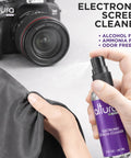 Close-up of Altura Photo electronic screen cleaner spray bottle in purple with microfiber cloth beside a Canon camera.
