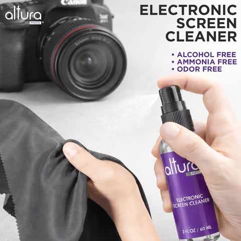 Close-up of Altura Photo electronic screen cleaner spray bottle in purple with microfiber cloth beside a Canon camera.