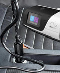 AirSense 11 DC Converter Car Charger On The Go plugged in vehicle with CPAP machine visible on seat