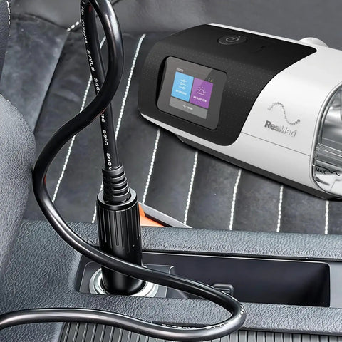 AirSense 11 DC Converter Car Charger On The Go plugged in vehicle with CPAP machine visible on seat