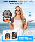 Woman holding Rechargeable Camping Fan With 20000mAh Battery, LED Light, And Built In Hook near the beach.
