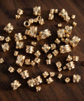 Assorted brass knurled threaded inserts displayed on a wooden surface from Brass Heat Set Inserts Kit