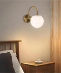 Gold Wall Sconce Mid Century Modern Wall Mount Light Hardwired Sconces Wall Light with Milky White Glass Shade indoor bedside lamp over bed.