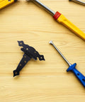Heavy Duty Black Iron T Hinge For Barn Doors And Sliding Sheds on wooden surface with tools nearby.