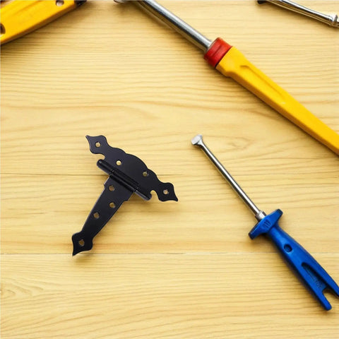 Heavy Duty Black Iron T Hinge For Barn Doors And Sliding Sheds on wooden surface with tools nearby.