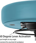 Adjustable Height Rolling Task Stool Built Tough For All Day Grind With Plush High Density Foam Cushion And Smooth Swiveling Nylon Casters For Shop Garage Spa Or Tattoo Room Setup In Blue showing lever activation for height adjustment.