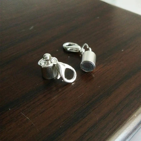 Close-up of two silver clasps from the 24 Piece Magnetic Lobster Clasps Set In Gold Color And Silver Color For Jewelry Making.