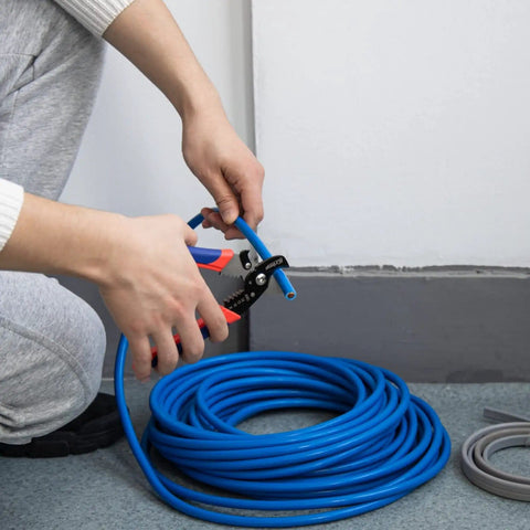 Person using 2 In 1 Wire Stripper And Cable Cutter for Multi Core Round And Coaxial Wires with 65Mn steel, rust-resistant finish.