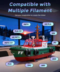 Adventurer 5M 3D printer showcasing filament compatibility with various materials, model boat displayed on table.