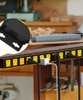 Long 12 Outlet Power Strip With 2100 Joules Surge Protector mounted on a workbench, displaying flat plug and wide spaced outlets.