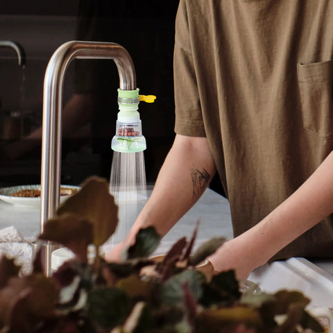 Person using 360 Rotating Faucet Filter Extenders Set For Sink Direct Water Flow And Splash Reduction on kitchen tap
