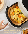 Go-To 6.5 Inch Round Air Fryer Paper Liners, 100 Pack Nonstick Parchment Paper in air fryer with cooked nuggets