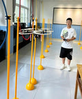 Child practicing flying a crash-proof drone trainer for beginners and pros; indoor obstacle course kit with PVC gates.