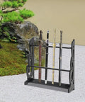 Six Hole Floor Standing Sword Display Rack with swords, black, in a natural setting; heavy duty katana holder, home or dojo.