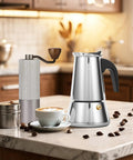 Four Cup Moka Pot Stovetop Espresso Maker In 304 Stainless Steel Induction Compatible Silver Finish on kitchen counter