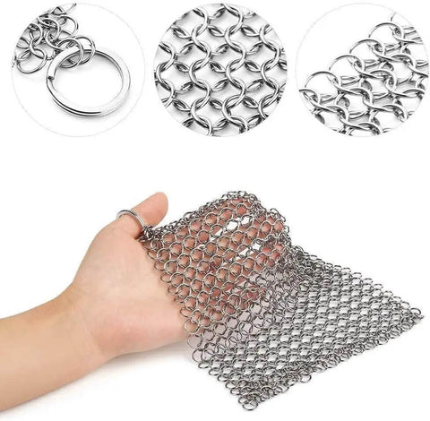 Hand holding 8x6 Inch Cast Iron Chainmail Scrubber for Safe Scratch Free Cleaning of Pre Seasoned Pans Griddles Barbecue Grills and Pots.