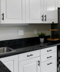 Modern kitchen with 10 Pack Matte Black 3 Inch Hole Center Cabinet Handles Stainless Steel Square Dresser Pulls on white cabinets.