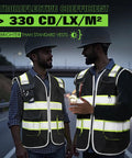 Men wearing Heavy Duty Ansi Class II High Visibility Safety Vest For Men Custom Printed Logo Reflective Work Gear With Eight Rugged Storage Pockets Black Large Size Top Shelf Durability at dusk.