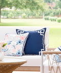 Coastal Navy Throw Pillow Cover 20x20 With White Embroidered Greek Key Frame, Weatherproof Polyester, on outdoor patio couch.