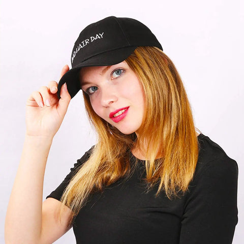 Woman wearing a customizable adjustable baseball cap for men and women with your text logo or image, breathable 100 percent cotton six panel trucker sun hat with pre curved bill and metal buckle closure, ideal gift for travel and everyday outings.