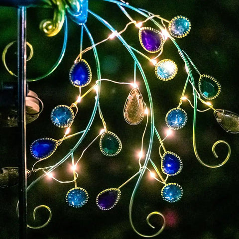 Metal Peacock Solar Garden Lights Stakes, Waterproof Path Lights for Outdoor Patio Lawn Yard Decor glow at night with LED lights.