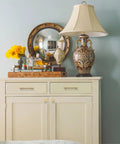 Decorated dresser with mirror and lamp, features champagne bronze cabinet knobs from Champagne Bronze Cabinet Knobs 10 Pack Champagne Gold Cabinet Pulls For Cabinets Drawers And Dressers Hardware For Cupboards Rust Proof Solid Metal Easy To Install 1.1 Inch Diameter Knobs Base 0.7 Inch Height 1.1 Inch.