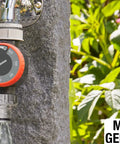 Easy To Use Mechanical Water Timer With Flow Control For Sprinklers And Drip Irrigation mounted on outdoor tap with garden background