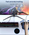 Ergonomic Memory Foam Wrist Rest Mouse Pad For All Day Comfort And Pain Relief During Gaming And Office Tasks Waterproof Surface With Non Slip Base Portable And Travel Friendly For Computer Laptop Home And Travel, shown with hand on mouse next to a keyboard and monitor. 