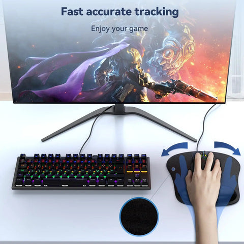 Ergonomic Memory Foam Wrist Rest Mouse Pad For All Day Comfort And Pain Relief During Gaming And Office Tasks Waterproof Surface With Non Slip Base Portable And Travel Friendly For Computer Laptop Home And Travel, shown with hand on mouse next to a keyboard and monitor. 