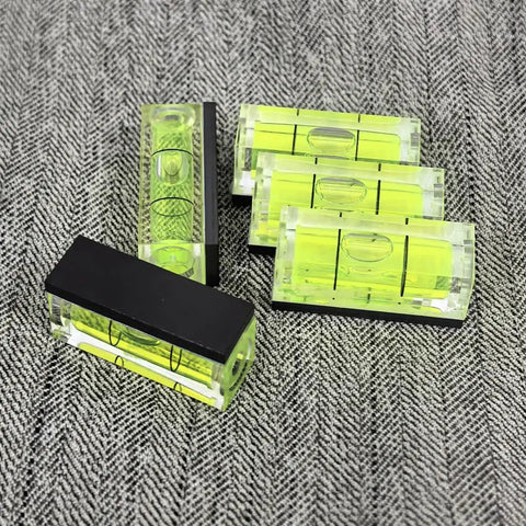 Top Tier 5 Piece Set Of Mini Magnetic Bubble Levels Your Go To Pocket Spirit Squares With Rock Strong Adhesion on a patterned background.