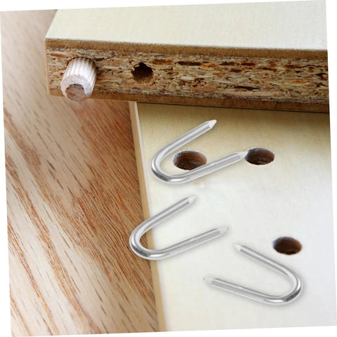 50 Pack U Shaped Fence Staples For Quick Install And Strong Hold Durable Metal Garden Stakes For Fences Landscaping And DIY Projects Multi Function Iron Pegs shown with wooden board