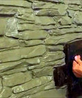 Applying Pro Grade Polyurethane Stone Texture Stamp Set For Concrete Realistic Granite Chipped Look Molds on a wall